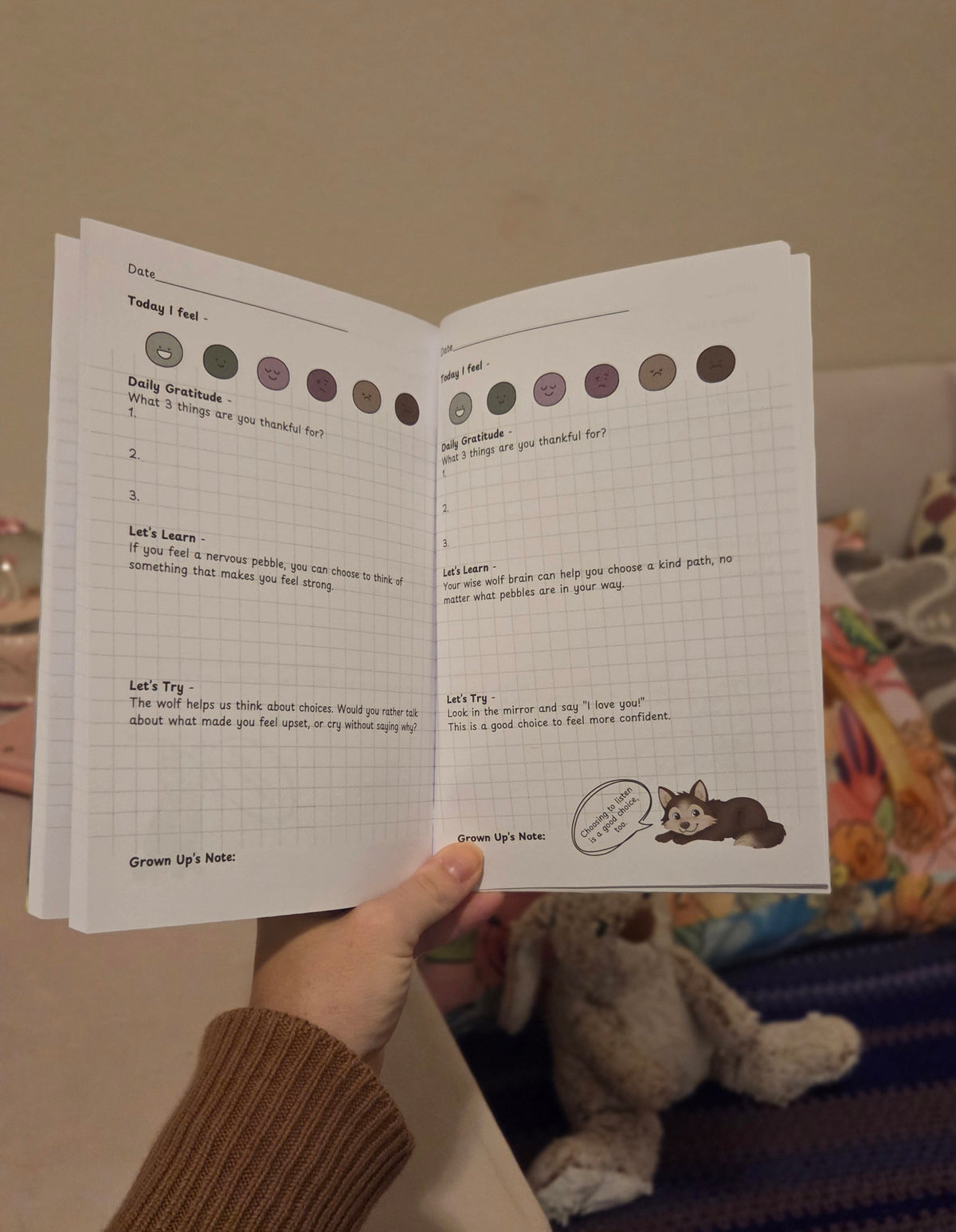 parent and child sharing a quiet moment together while writing in a guided journal for secure attachment.